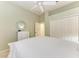 Spacious bedroom with a white ceiling fan, closet doors and a calming light green color at 8782 49Th E Ter, Bradenton, FL 34211
