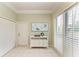 Inviting entryway with white door, closet and blinds adjacent to a white console table and decorative wall art at 8782 49Th E Ter, Bradenton, FL 34211