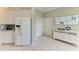Inviting entryway adjacent to kitchen, with white door, closet and blinds next to white console table and decorative wall art at 8782 49Th E Ter, Bradenton, FL 34211