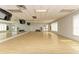 Spacious fitness center featuring hardwood floors, large mirrors, and ample natural light at 8782 49Th E Ter, Bradenton, FL 34211
