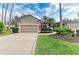 Charming home features a well-manicured lawn, lush landscaping, and a two-car garage at 8782 49Th E Ter, Bradenton, FL 34211