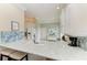 Kitchen counter with a sink, tiled backsplash, breakfast bar seating, and modern appliances creating a functional and inviting space at 8782 49Th E Ter, Bradenton, FL 34211
