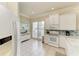 Bright kitchen with white cabinets, appliances, and a view of the window, offering a clean and functional cooking space at 8782 49Th E Ter, Bradenton, FL 34211