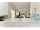 Kitchen counter with sink overlooking dining and living spaces, with stainless steel appliances and faucet at 8782 49Th E Ter, Bradenton, FL 34211