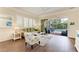 Bright living room with plantation shutters, a comfortable sofa, accent chair, and an inviting view of the outdoor pool area at 8782 49Th E Ter, Bradenton, FL 34211