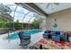 Inviting screened-in patio with a refreshing pool, comfortable seating, and lush landscaping at 8782 49Th E Ter, Bradenton, FL 34211