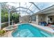 A beautiful screened-in pool with a spa, lounge chairs, and an outdoor seating area for relaxation and entertainment at 8782 49Th E Ter, Bradenton, FL 34211