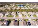 Aerial view of a light grey home and a neighborhood with a small lake and pool at 922 Fernleaf Run, Bradenton, FL 34212