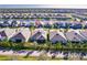 Aerial view of a neighborhood with a lake and well-maintained landscaping at 922 Fernleaf Run, Bradenton, FL 34212