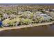Expansive aerial view of a home with large lawn, mature trees, and waterfront access at 922 Fernleaf Run, Bradenton, FL 34212