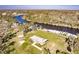 Aerial view of a home with access to a river surrounded by lush trees at 922 Fernleaf Run, Bradenton, FL 34212