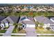 Aerial view of a light grey home with solar panels and a three car garage at 922 Fernleaf Run, Bradenton, FL 34212