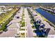 Aerial view of a quiet neighborhood with houses lining a long street and a small lake at 922 Fernleaf Run, Bradenton, FL 34212