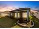 A covered screened lanai overlooks the backyard with lush green grass and landscaping at 922 Fernleaf Run, Bradenton, FL 34212