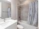 This bathroom features a vanity, mirror, toilet, tub, and a blue shower curtain at 922 Fernleaf Run, Bradenton, FL 34212