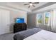 Bedroom with large windows, a dark dresser, and a ceiling fan at 922 Fernleaf Run, Bradenton, FL 34212