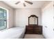 Bright bedroom featuring a bed, dark wood dresser with mirror, and a double door closet at 922 Fernleaf Run, Bradenton, FL 34212