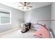 This bedroom offers a ceiling fan, neutral walls, window, and furniture at 922 Fernleaf Run, Bradenton, FL 34212