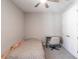 The bedroom offers a ceiling fan, neutral walls, closet doors, and a desk with a chair at 922 Fernleaf Run, Bradenton, FL 34212