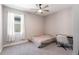 This bedroom features a ceiling fan, window with curtains, neutral walls, and a desk with a chair at 922 Fernleaf Run, Bradenton, FL 34212
