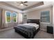Bedroom featuring neutral colors, a ceiling fan, and a large windows allowing natural light at 922 Fernleaf Run, Bradenton, FL 34212