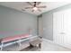 The bedroom offers a ceiling fan, neutral walls, closet doors, and furniture at 922 Fernleaf Run, Bradenton, FL 34212