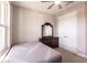 Bright bedroom featuring a bed, dark wood dresser with mirror, and a double door closet at 922 Fernleaf Run, Bradenton, FL 34212