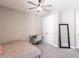 The bedroom has a ceiling fan, a mirror, closet doors, neutral walls, and a desk with a chair at 922 Fernleaf Run, Bradenton, FL 34212