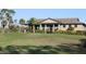 Community outdoor pavilion overlooking a large grassy field with some trees and shrubbery at 922 Fernleaf Run, Bradenton, FL 34212