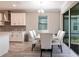 Dining area showcasing a modern table with white chairs and sliding glass doors to the outside at 922 Fernleaf Run, Bradenton, FL 34212