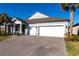 Attractive home featuring a brick driveway and a spacious two-car garage at 922 Fernleaf Run, Bradenton, FL 34212
