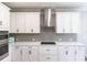 Bright kitchen featuring white cabinetry, stainless steel appliances, and subway tile backsplash at 922 Fernleaf Run, Bradenton, FL 34212