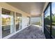 Screened in lanai with brick flooring, ceiling, and access to interior with sliding glass doors at 922 Fernleaf Run, Bradenton, FL 34212