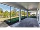Screened in lanai with brick flooring, ceiling, and backyard views at 922 Fernleaf Run, Bradenton, FL 34212