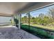 Screened in lanai with brick flooring, ceiling, and backyard views at 922 Fernleaf Run, Bradenton, FL 34212