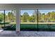 Screened in lanai with brick flooring, ceiling, and backyard views at 922 Fernleaf Run, Bradenton, FL 34212