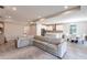 Open-concept living area flowing into a modern kitchen, featuring an expansive sectional and dining area at 922 Fernleaf Run, Bradenton, FL 34212