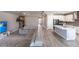 Open-concept living area flowing into a modern kitchen, featuring an expansive sectional at 922 Fernleaf Run, Bradenton, FL 34212