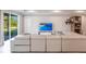Bright open concept living space with tile floors and a large sectional couch at 922 Fernleaf Run, Bradenton, FL 34212