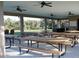 Spacious covered outdoor pavilion with picnic tables and BBQ area overlooking a green space at 922 Fernleaf Run, Bradenton, FL 34212
