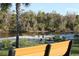 Park bench overlooking a serene view of the river and natural landscape at 922 Fernleaf Run, Bradenton, FL 34212