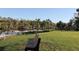 Park bench on green lawn overlooking a waterway at 922 Fernleaf Run, Bradenton, FL 34212