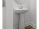 Bathroom featuring a pedestal sink, oval mirror, and wood flooring, combining simplicity with modern elegance at 10203 Milky Way Cir, Sarasota, FL 34241