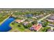 Scenic aerial view of well-maintained homes with screened lanais along a peaceful street and pretty ponds at 110 167Th E Blvd, Bradenton, FL 34212