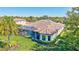 An overhead view of the home, showcasing its tile roof, screened-in pool, and landscaped backyard at 110 167Th E Blvd, Bradenton, FL 34212