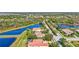 Community shot of beautiful homes with red tile roofs, well-kept landscaping, and tranquil lakes at 110 167Th E Blvd, Bradenton, FL 34212