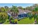 Aerial view of the home showcasing the screened-in pool, lush landscaping, and tile roof at 110 167Th E Blvd, Bradenton, FL 34212