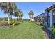 Lush backyard with vibrant landscaping, including a screened-in pool area and plenty of green space at 110 167Th E Blvd, Bradenton, FL 34212