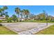 Community basketball court featuring palm trees, beautiful landscape, and grass perimeter at 110 167Th E Blvd, Bradenton, FL 34212