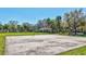 Outdoor basketball court with hoop, and a picnic pavillion under shady trees in the background at 110 167Th E Blvd, Bradenton, FL 34212